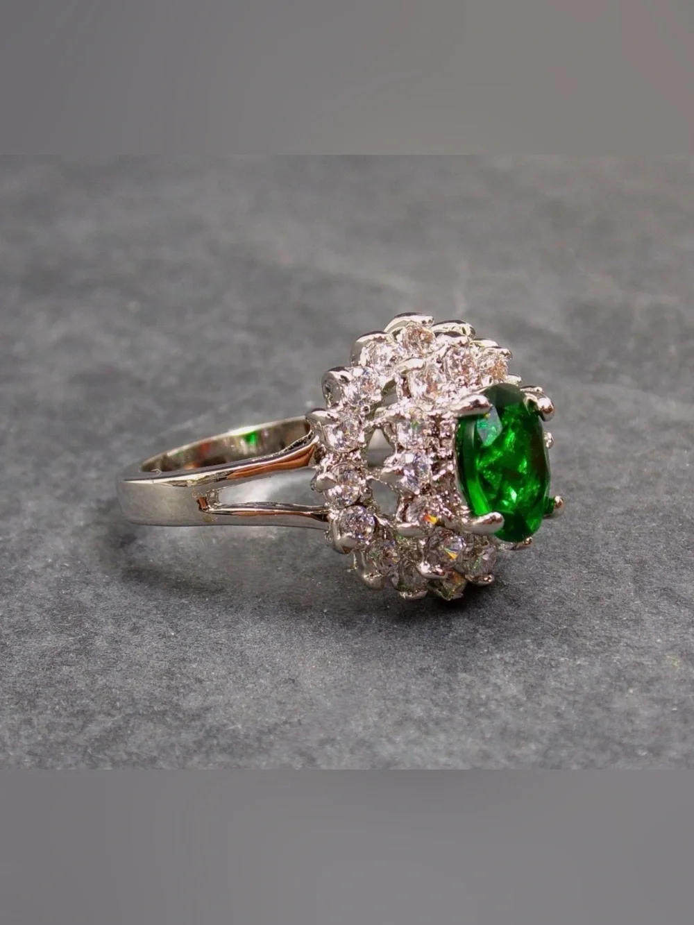 Green oval cubic zirconia stone ring w/ clear stones in a raised setting SZ 6.5